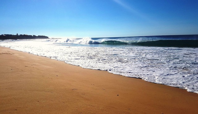 Let the waves hit your feet, let the sand be your seat! beach across the road!