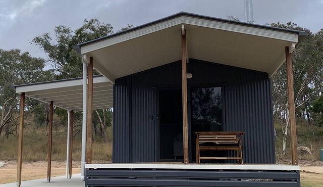 Modern studio cabin set amongst vineyards, bushland and grazing paddocks.